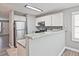 Open kitchen featuring granite countertops, stainless steel appliances, and adjacent breakfast bar at 87 Davis Mill Ct, Lawrenceville, GA 30044