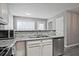 Modern kitchen featuring stainless steel appliances, granite countertops, and ample cabinet space at 87 Davis Mill Ct, Lawrenceville, GA 30044