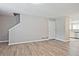 Open-concept living room with wood floors, neutral walls, and access to the kitchen, creating a seamless flow at 87 Davis Mill Ct, Lawrenceville, GA 30044