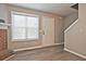 Living room with a fireplace, wood floors, a large window and a door that lets in natural light at 87 Davis Mill Ct, Lawrenceville, GA 30044