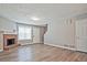 Bright and inviting living area with a cozy fireplace, sleek wood floors, and neutral walls, creating a serene ambiance at 87 Davis Mill Ct, Lawrenceville, GA 30044