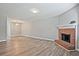 Spacious living room featuring a fireplace, hardwood flooring, and neutral paint, seamlessly connected to other rooms at 87 Davis Mill Ct, Lawrenceville, GA 30044