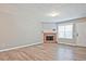 Cozy living room featuring wood floors, a fireplace, and a bright white door with a large window at 87 Davis Mill Ct, Lawrenceville, GA 30044