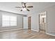 Spacious main bedroom featuring hardwood floors, a ceiling fan, and ensuite bathroom at 87 Davis Mill Ct, Lawrenceville, GA 30044