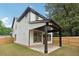 Exterior view of the home highlighting the backyard's patio, fenced yard, and landscaping at 1158 Welch Sw St, Atlanta, GA 30310