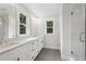 Beautiful bathroom with dual sinks, a large mirror, and a glass-enclosed shower at 1158 Welch Sw St, Atlanta, GA 30310