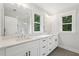 Bright bathroom featuring dual sinks, quartz countertop, and elegant fixtures at 1158 Welch Sw St, Atlanta, GA 30310