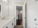 Bathroom featuring a wide countertop with black hardware, white tile, and a shower at 1158 Welch Sw St, Atlanta, GA 30310