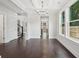 Bright dining room featuring dark wood floors, a modern chandelier, and ample natural light at 1158 Welch Sw St, Atlanta, GA 30310
