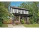 Charming two-story home with a front porch, dark trim, and well-maintained landscaping at 1158 Welch Sw St, Atlanta, GA 30310