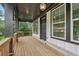 Inviting front porch with wood flooring, dark support columns, and a blue front door at 1158 Welch Sw St, Atlanta, GA 30310