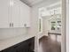 Bright kitchen with white cabinets, dark hardware, tile backsplash, and beautiful hardwood flooring at 1158 Welch Sw St, Atlanta, GA 30310