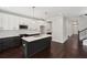 Modern kitchen showcasing an island, white cabinets, and dark hardwood floors at 1158 Welch Sw St, Atlanta, GA 30310