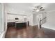 Open-concept kitchen with island, hardwood floors, and view to the living room and staircase at 1158 Welch Sw St, Atlanta, GA 30310
