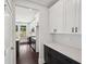 Modern kitchen features white cabinets, dark hardware, quartz countertops, and hardwood flooring at 1158 Welch Sw St, Atlanta, GA 30310