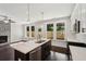 Open kitchen with island, pendant lighting, stainless appliances, and adjacent living room at 1158 Welch Sw St, Atlanta, GA 30310