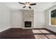Bright living room featuring a stone fireplace, ceiling fan, and hardwood floors at 1158 Welch Sw St, Atlanta, GA 30310