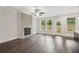 Bright living room with a stone fireplace, hardwood floors, and a view of the backyard at 1158 Welch Sw St, Atlanta, GA 30310