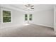Primary bedroom featuring a tray ceiling and many windows at 1158 Welch Sw St, Atlanta, GA 30310