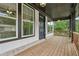 Inviting front porch with wood flooring, black accents, and multiple windows for ample natural light at 1158 Welch Sw St, Atlanta, GA 30310