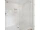 Elegant shower with a glass door, marble tile, and hexagon floor tiles at 1158 Welch Sw St, Atlanta, GA 30310