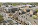 An aerial view showcases the neighborhood, with tree-lined streets, sidewalks, and brick townhomes at 310 Rose Garden Ln, Alpharetta, GA 30009