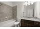Bathroom features a tub-shower combo, gray tile, and granite vanity at 310 Rose Garden Ln, Alpharetta, GA 30009