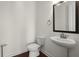 Stylish half-bathroom featuring a pedestal sink and neutral tones at 310 Rose Garden Ln, Alpharetta, GA 30009