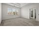 Spacious bedroom with tray ceiling and large windows, leading into ensuite bathroom at 310 Rose Garden Ln, Alpharetta, GA 30009