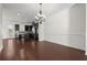 Dining room with hardwood floors, decorative lighting, and open access to the kitchen at 310 Rose Garden Ln, Alpharetta, GA 30009