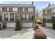 Beautiful brick townhomes boast private balconies and attached garages with nicely paved driveways at 310 Rose Garden Ln, Alpharetta, GA 30009