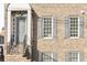 The exterior features a brick facade, classic windows with shutters, and an inviting front entry at 310 at 310 Rose Garden Ln, Alpharetta, GA 30009