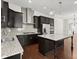 Well-equipped kitchen with stainless steel appliances, granite counters, and open floor plan at 310 Rose Garden Ln, Alpharetta, GA 30009