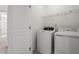 Modern laundry room equipped with washer, dryer, and storage space at 310 Rose Garden Ln, Alpharetta, GA 30009