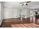 Spacious living room featuring hardwood floors, ceiling fan, and natural light from many windows at 310 Rose Garden Ln, Alpharetta, GA 30009