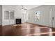 A bright living room boasts hardwood flooring, built-in shelving, a cozy fireplace, and ample natural light at 310 Rose Garden Ln, Alpharetta, GA 30009