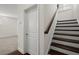 Dark wood-trimmed stairway to second story features dark wood steps and white risers at 310 Rose Garden Ln, Alpharetta, GA 30009