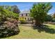 Scenic backyard with a lush lawn, mature trees, and a spacious deck, perfect for outdoor gatherings at 3175 Lake Seminole Pl, Buford, GA 30519