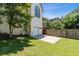 The home's backyard features a concrete side patio, green lawn, and a fenced border at 3175 Lake Seminole Pl, Buford, GA 30519