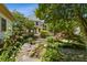 The home's backyard features a stone path, waterfall feature, a wood deck, and mature shade trees at 3175 Lake Seminole Pl, Buford, GA 30519