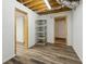 Unfinished basement with wood look floors and neutral doors is a flexible area for storage or design at 3175 Lake Seminole Pl, Buford, GA 30519