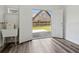 Basement with wood look floors and access to the yard, complete with utility sink, allows for easy clean up at 3175 Lake Seminole Pl, Buford, GA 30519