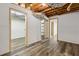 Unfinished basement with wood look floors and exposed beams provides a flexible area for storage or design at 3175 Lake Seminole Pl, Buford, GA 30519