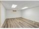 Unfinished basement with wood look floors and bright lighting providing a flexible area for storage or design at 3175 Lake Seminole Pl, Buford, GA 30519
