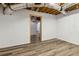 Unfinished basement with wood look floors and bright lighting provides a flexible area for storage or design at 3175 Lake Seminole Pl, Buford, GA 30519