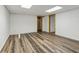 Unfinished basement with wood look floors and bright white walls provides a clean area for storage or design at 3175 Lake Seminole Pl, Buford, GA 30519