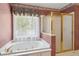 A bathroom view featuring a bathtub and a glass door shower at 3175 Lake Seminole Pl, Buford, GA 30519
