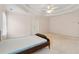 Spacious bedroom with tray ceiling, neutral walls, and double closet doors at 3175 Lake Seminole Pl, Buford, GA 30519