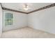 Bedroom boasts a large window, neutral walls, and decorative trim along the ceiling at 3175 Lake Seminole Pl, Buford, GA 30519