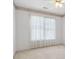 Bright bedroom with ceiling fan and natural light coming from a large window at 3175 Lake Seminole Pl, Buford, GA 30519